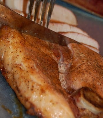 Slicked meat with a knife and a fork