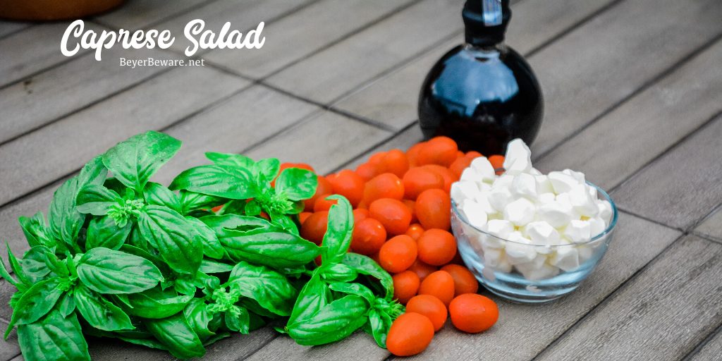 Caprese Salad Ingredients of fresh mozzarella cheese, tomatoes, basil, and balsamic vinegar