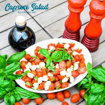 Caprese Salad is a simple fresh tomato salad recipe made with fresh tomatoes, basil, and mozzarella with balsamic vinegar and olive oil for a quick and easy side dish all summer long.