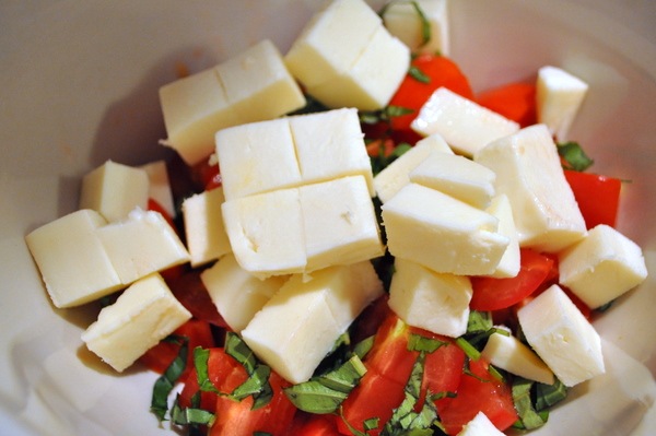 Layer tomatoes and mozzarella on a platter, tucking basil in between. For a rustic version, toss them together in a bowl.
