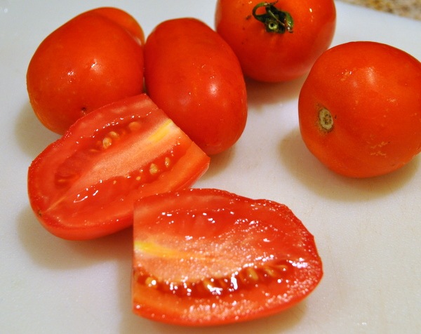 Wash and slice them—halved if using cherry/grape or sliced into wedges for larger tomatoes.