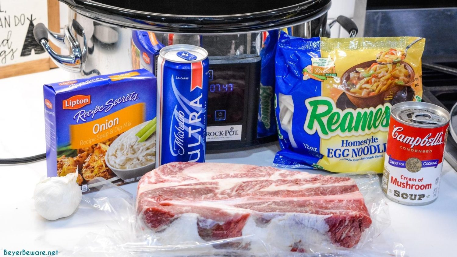 Crock pot beef and noodles made with an arm roast or rump roast and beer, cream of mushroom soup, onion soup mix, garlic, and egg noodles.