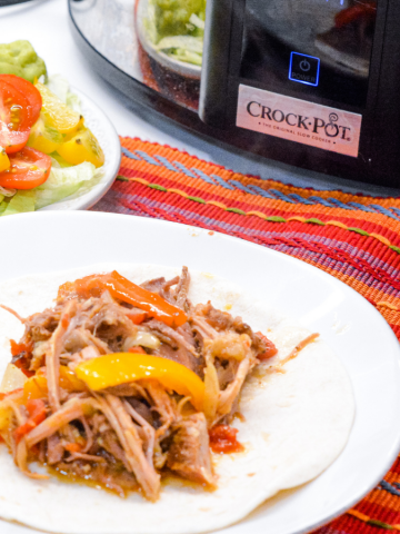 Crock Pot Pork Fajitas recipe is easy to make in a slow cooker along with a pork loin roast, can of Rotel, fajita seasonings, onions and peppers slow cooked all day for an easy weeknight dinner or Taco Tuesday.