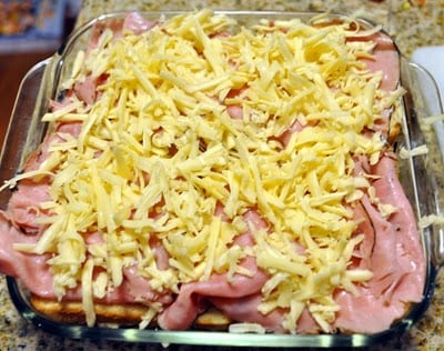 shredded cheese on sliced ham
