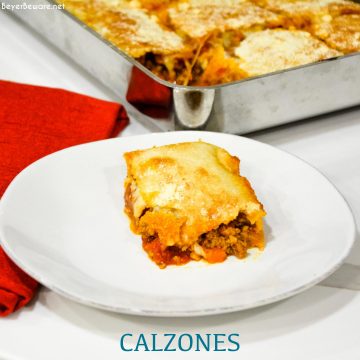 Deep-Dish Pan Calzones are a stuffed pizza recipe using a large thin pizza dough that literally wraps your favorite pizza toppings in dough in a 13x9 pan.