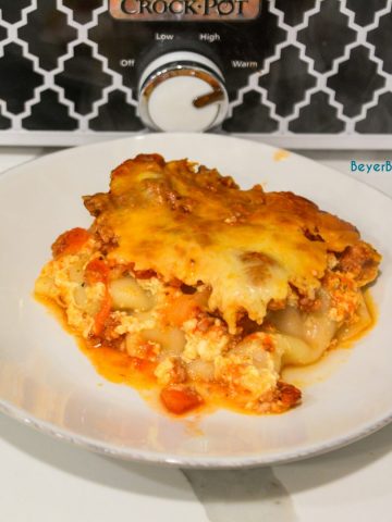 Crock pot lasagna is an easy lasagna recipe using no-boil or regular lasagna noodles that can slow cook in your casserole crock pot all day long.