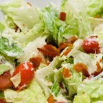 BLT salad is a simple salad recipe combining lettuce, tomatoes, mozzarella cheese, and bacon crumbles with a homemade creamy dressing that is a cross between ranch and caesar dressing.