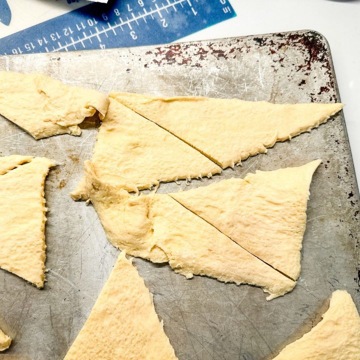 Open a can of crescent rolls. Break each triangle apart and then cut each triangle in half.