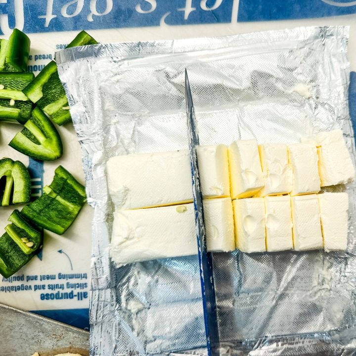 Cut 2-3 jalapenos in half lengthwise. Take the seed out and then cut into bite-size pieces. Also cut the block of cream cheese into small pieces.