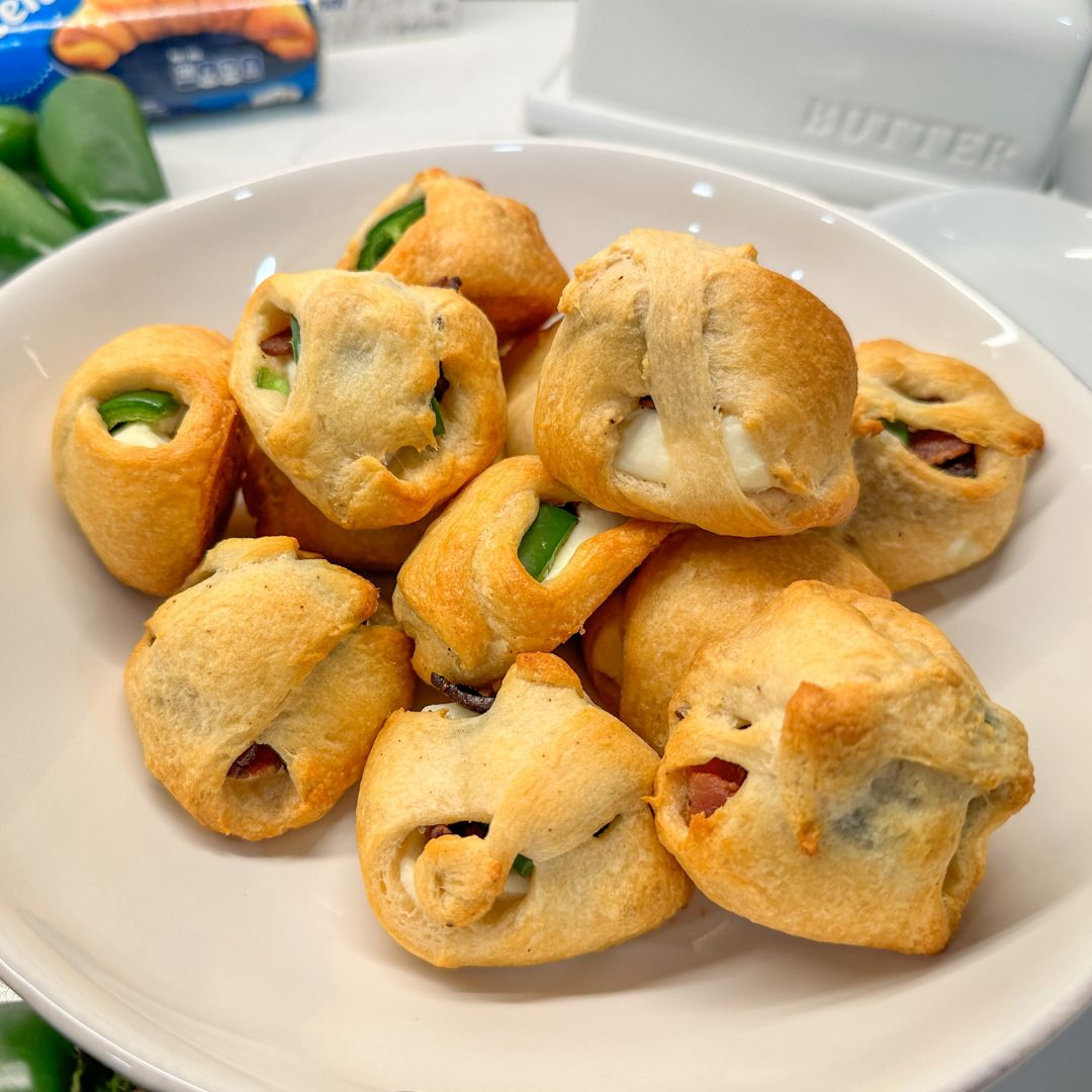 This unique jalapeño popper recipe is just four ingredients - crescent rolls, cream cheese, bacon, and jalapeños.