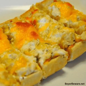 Cheesy Artichoke Bread is a simple appetizer combining artichoke hearts with lots of cheese, garlic, and onions on Italian bread for perfect finger food for any party. #Appetizers #Artichokes #Cheese #CheesyBread