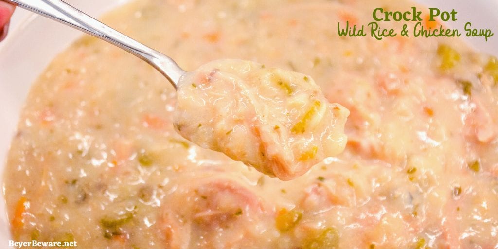 Crock pot creamy chicken and wild rice soup is slow-cooked all day in a base of carrots, celery, onions, and garlic and then made creamy with a simple white sauce to quickly become your family\'s favorite hearty soup recipe.