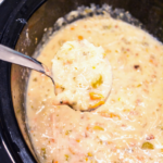 Crockpot creamy chicken and wild rice soup recipe is made with long grain and wild rice, celery, carrots, onions, chicken, and milk to form a cream based chicken soup.