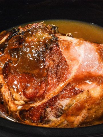 Crock Pot Holiday Ham is slow cooked in brown sugar, maple syrup, and pineapple juice making this crock pot maple ham perfect for the Thanksgiving or Christmas dinner table.