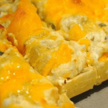 Cheesy Artichoke Bread is a simple appetizer combining artichoke hearts with lots of cheese, garlic, and onions on Italian bread for perfect finger food for any party. #Appetizers #Artichokes #Cheese #CheesyBread