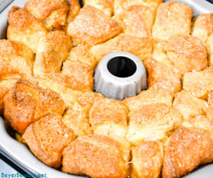 Monkey bread is a caramel pull-apart bread made with Grands biscuits, butter, sugar, and cinnamon then baked in a bundt cake pan for a gooey breakfast bread.