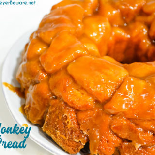 Monkey bread is a caramel pull-apart bread made with Grands biscuits, butter, sugar, and cinnamon then baked in a bundt cake pan for a gooey breakfast bread.