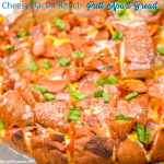 The cheesy ranch bacon pull-apart bread recipe is an easy appetizer made with a Hawaiian Bread round loaf that is filled with bacon, cheese, and, green onions ranch butter then baked to gooey crack bread perfection.