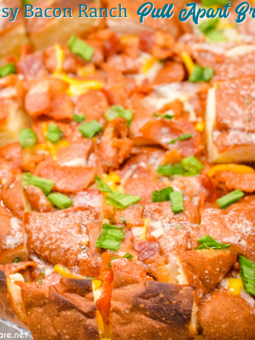 The cheesy ranch bacon pull-apart bread recipe is an easy appetizer made with a Hawaiian Bread round loaf that is filled with bacon, cheese, and, green onions ranch butter then baked to gooey crack bread perfection.