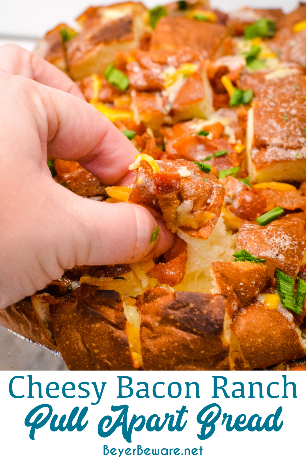 The cheesy ranch bacon pull-apart bread recipe is an easy appetizer made with a Hawaiian Bread round loaf that is filled with bacon, cheese, and, green onions ranch butter then baked to gooey crack bread perfection.