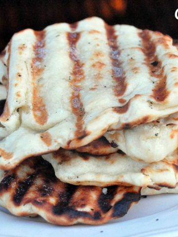 One of our favorite things in the summer is grilled garlic naan bread recipe. It is an easy to make yeast bread and cooks quickly on the grill.