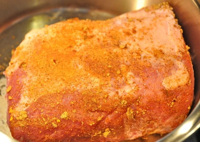 pork loin searing in a hot skillet