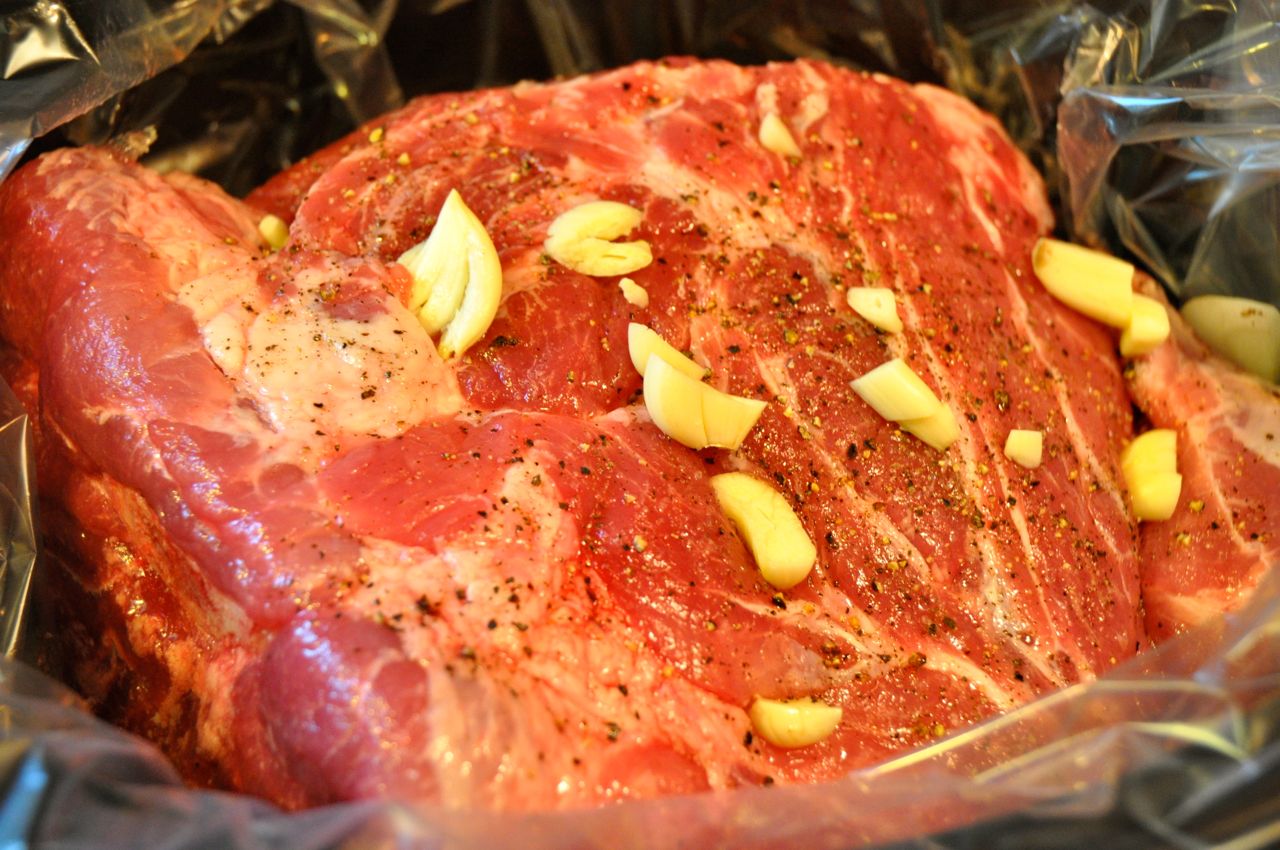 pork shoulder with garlic in a crock pot