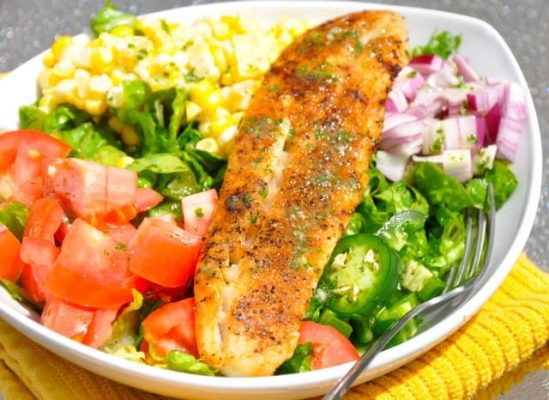 Blackened Fish Taco Salad recipe is a refreshing blend your favorite veggies and meat for a taco salad and dressed in a cilantro lime dressing.