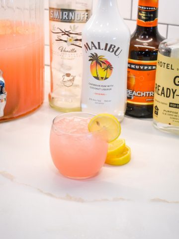 An easy spiked island lemonade recipe mixing country time pink lemonade, Malibu rum, vodka, gin, and peach schnapps.