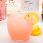 An easy spiked island lemonade recipe mixing country time pink lemonade, Malibu rum, vodka, gin, and peach schnapps.
