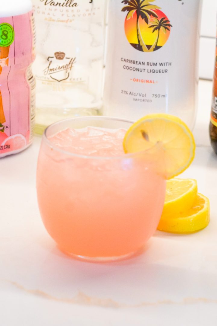 An easy spiked island lemonade recipe mixing country time pink lemonade, Malibu rum, vodka, gin, and peach schnapps.