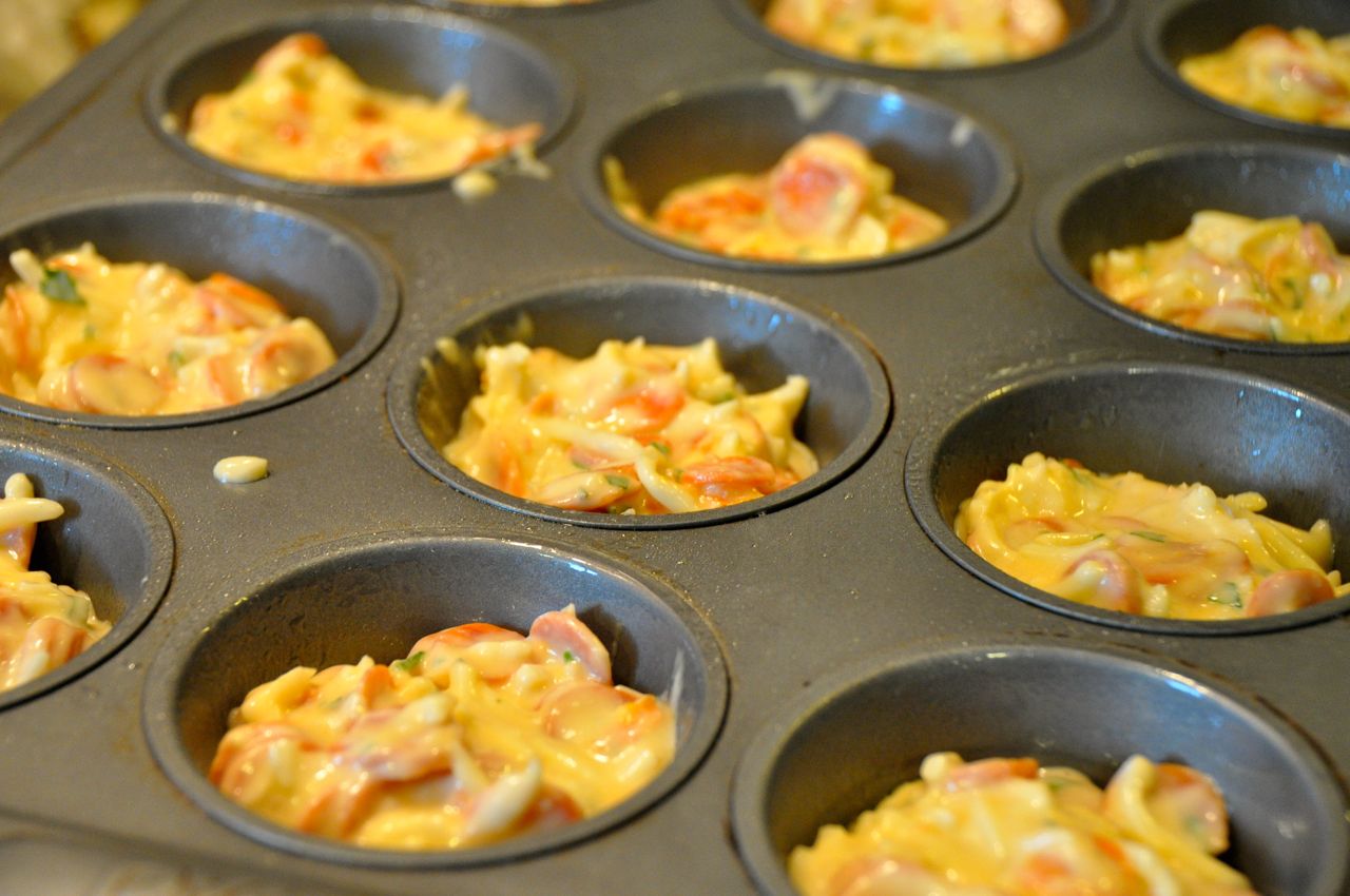 muffin tins filled with pizza batter