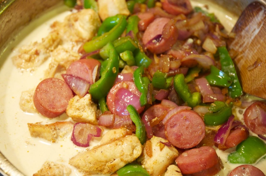 mixing together cajun chicken pasta