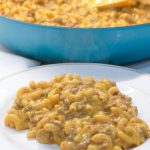 Homemade hamburger helper cheeseburger macaroni is made with ground beef, macaroni, Velveeta, and a sauce made with ketchup and mustard.