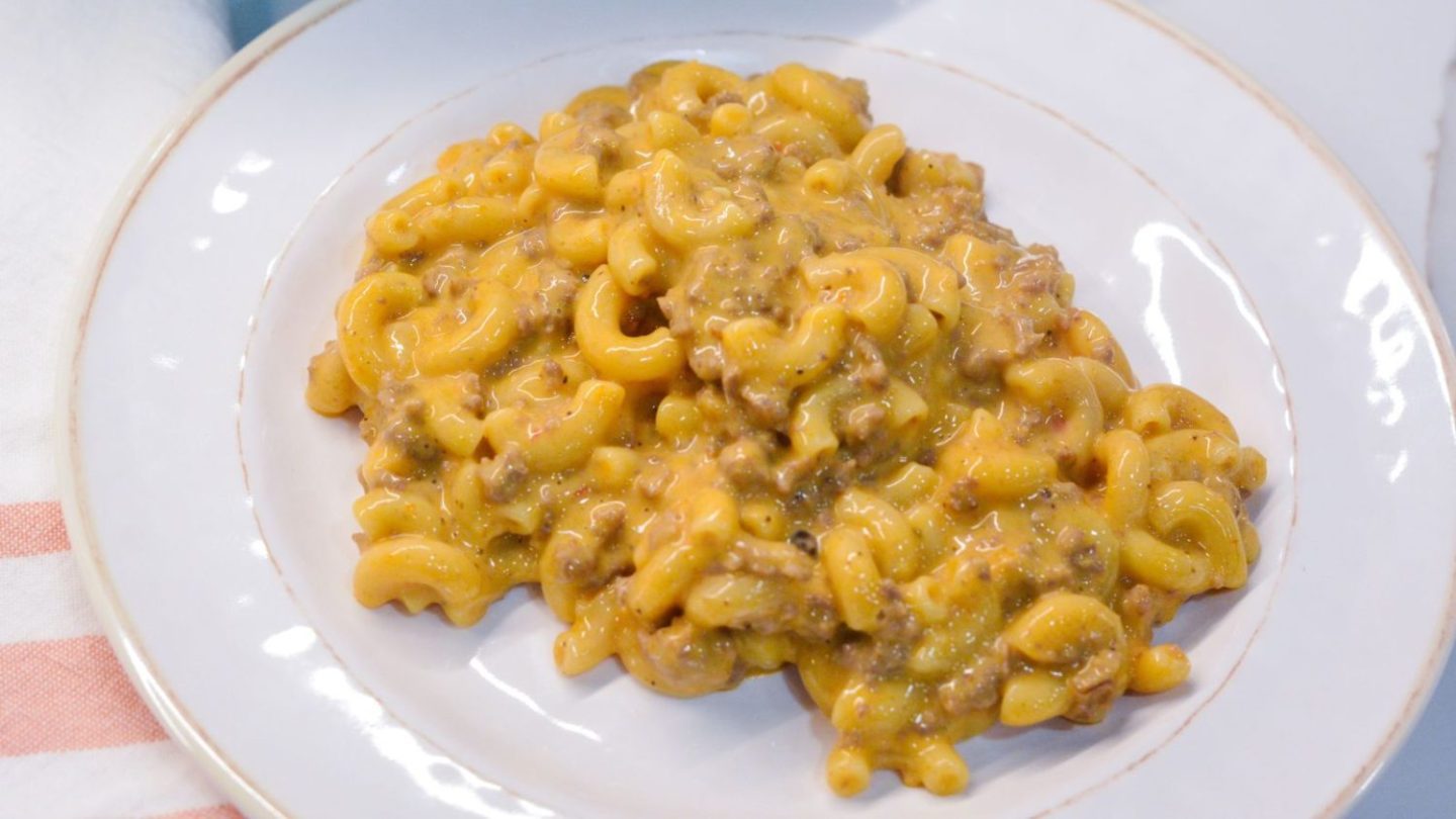 Homemade hamburger helper cheeseburger macaroni is made with ground beef, macaroni, Velveeta, and a sauce made with ketchup and mustard.