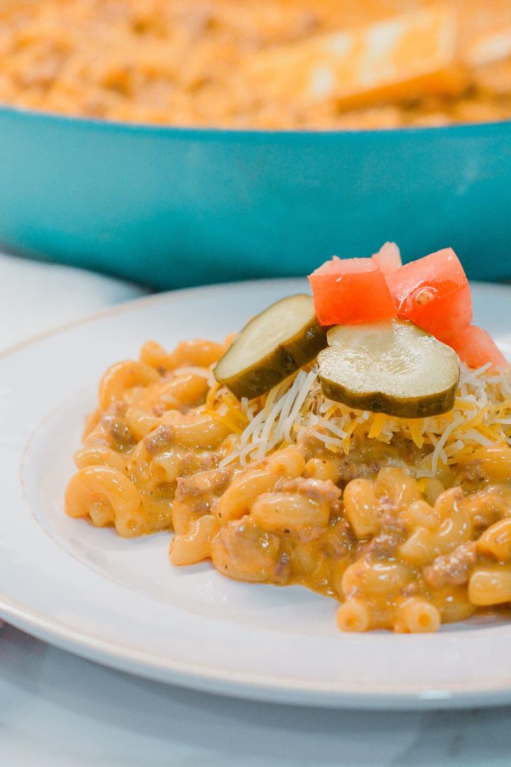 Homemade hamburger helper cheeseburger macaroni is made with ground beef, macaroni, Velveeta, and a sauce made with ketchup and mustard.