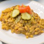 Homemade hamburger helper cheeseburger macaroni is made with ground beef, macaroni, Velveeta, and a sauce made with ketchup and mustard.