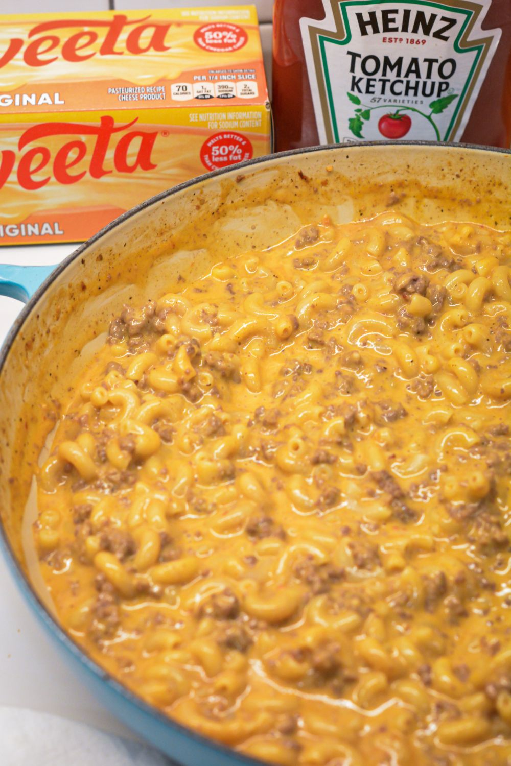 Homemade hamburger helper cheeseburger macaroni is made with ground beef, macaroni, Velveeta, and a sauce made with ketchup and mustard.