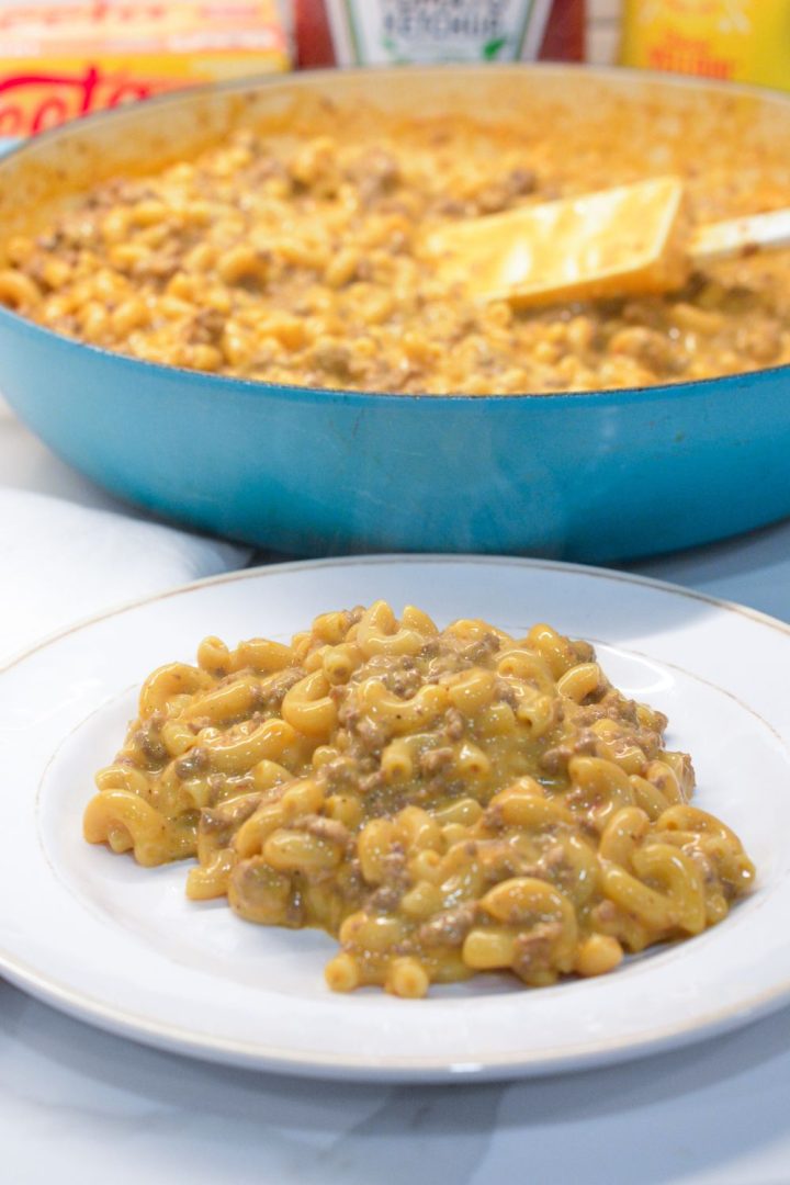 Homemade hamburger helper cheeseburger macaroni is made with ground beef, macaroni, Velveeta, and a sauce made with ketchup and mustard. 