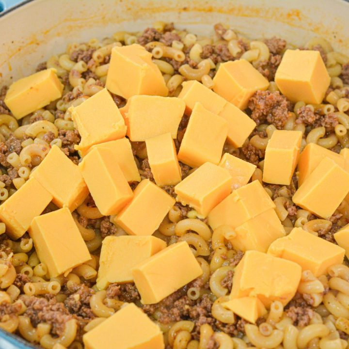 Once the macaroni is tender, add Velveeta, cubed to the mixture. Stir until the cheese is melted. To make creamier, add a half cup of milk as well.