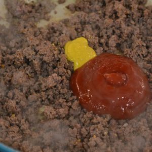 cooked ground beef with ketchup and mustard.