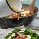 Spinach salad with hot bacon dressing is an easy spinach salad recipe made with bacon, tomatoes, and eggs tossed in a warm dressing that has a mixture of tangy sweetness and salty from the bacon. #bacon #spinach #salad #bacon #BaconDressing #SpinachSalad #EasterRecipes #keto