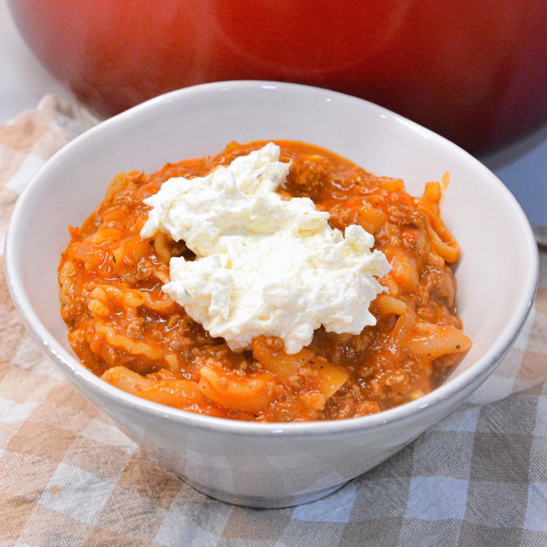 Lasagna soup recipe with ricotta is made with ground pork or beef, Italian seasonings, your favorite pasta, and topped with cheese.