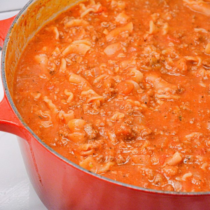 Lasagna soup recipe with ricotta is made with ground pork or beef, Italian seasonings, your favorite pasta, and topped with cheese.