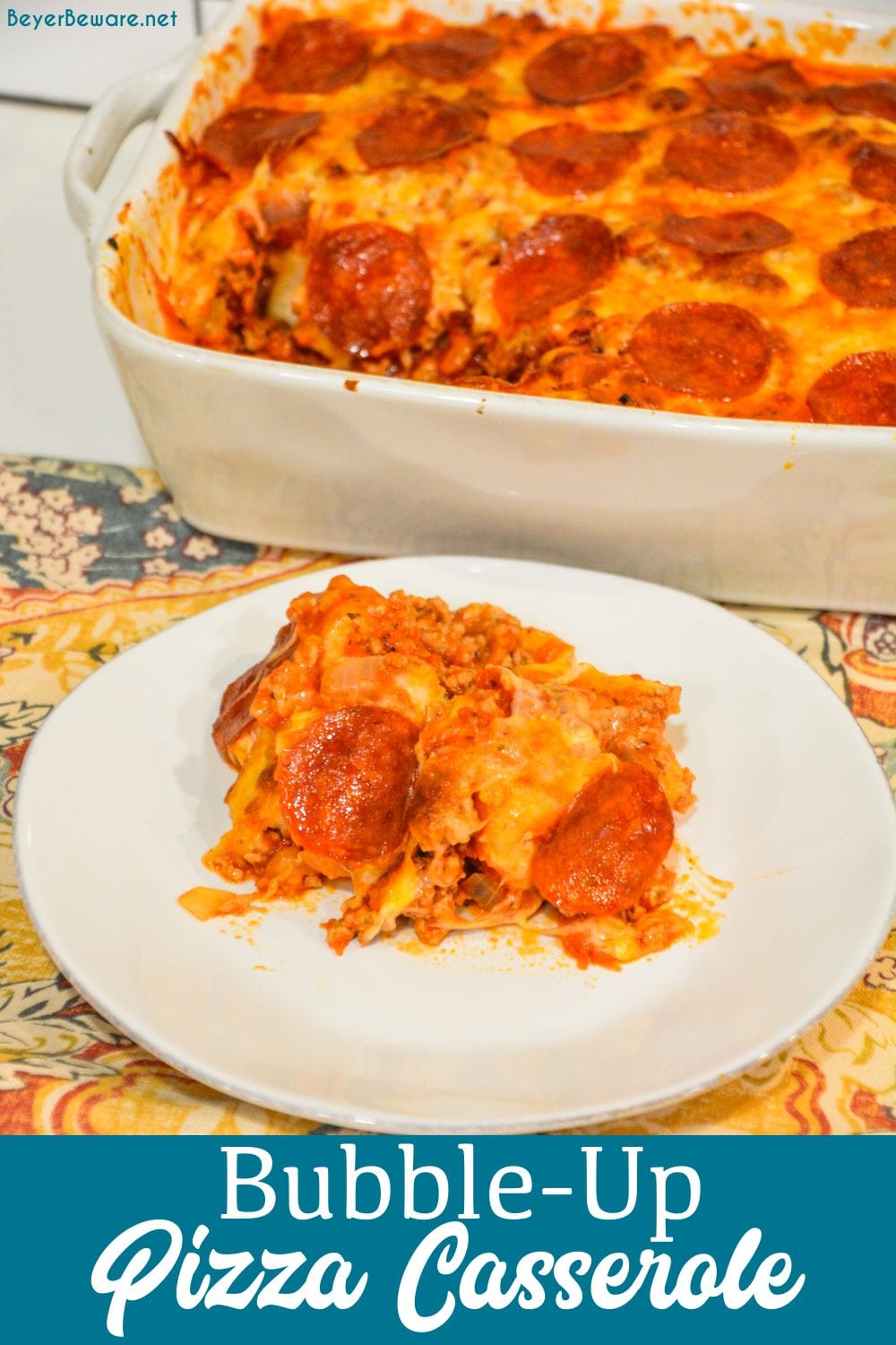 Bubble-Up pizza casserole is an easy weeknight meal since the casserole is made with grands biscuits, spaghetti sauce and your favorite pizza toppings.