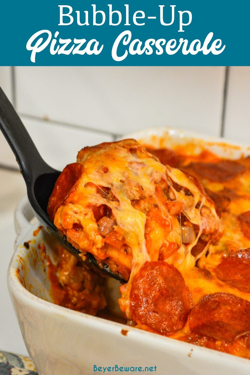 Bubble-Up pizza casserole is an easy weeknight meal since the casserole is made with grands biscuits, spaghetti sauce and your favorite pizza toppings.