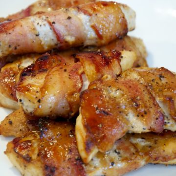 A baked honey mustard bacon wrapped chicken tenders fit perfectly into little hands and is an easy chicken recipe the whole family will love.