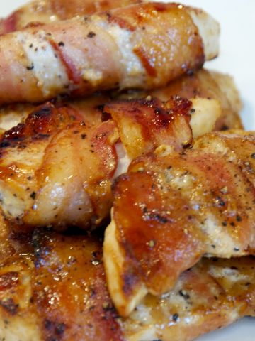 A baked honey mustard bacon wrapped chicken tenders fit perfectly into little hands and is an easy chicken recipe the whole family will love.