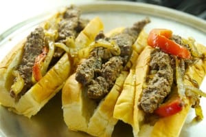 cubed steak, onions and peppers in hot dog buns