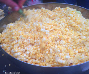 Cut the kernels off the raw cobs into a large bowl.